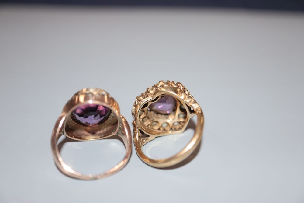 Two early 20th century yellow metal, amethyst and seed pearl set dress rings